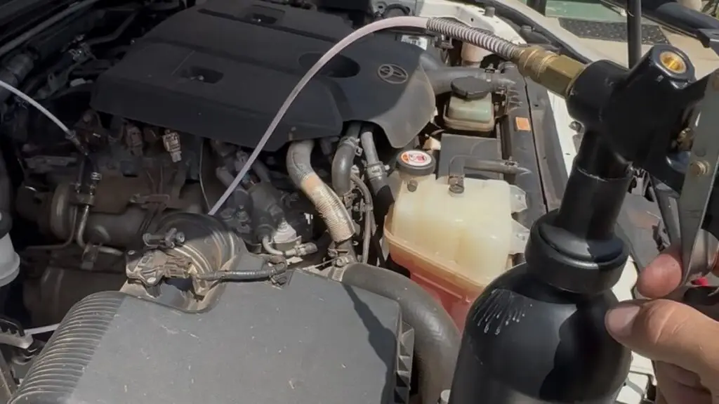 On-car DPF cleaning equipment connected to a Toyota diesel engine during a mobile service call